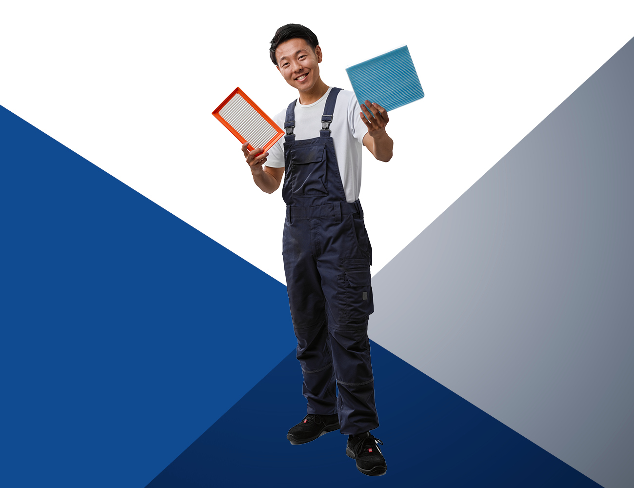 Car mechanic holding a cabin filter in one hand and an air filter in the other